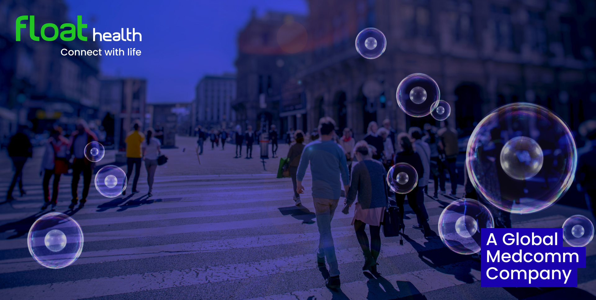 Blue-tinted city square with people crossing a street and floating soap bubbles. Top-left has the green "float health" logo; bottom-right says "A Global Medcomm Company" in a blue box. The tagline is "Connect with life."
